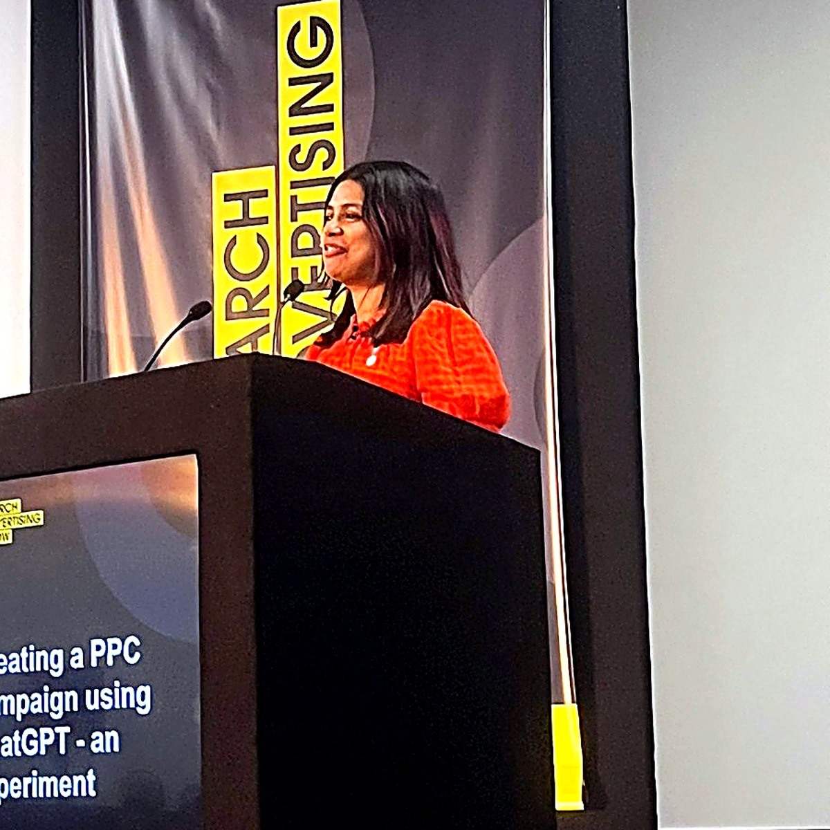 Farah speaking on stage (photo 1)