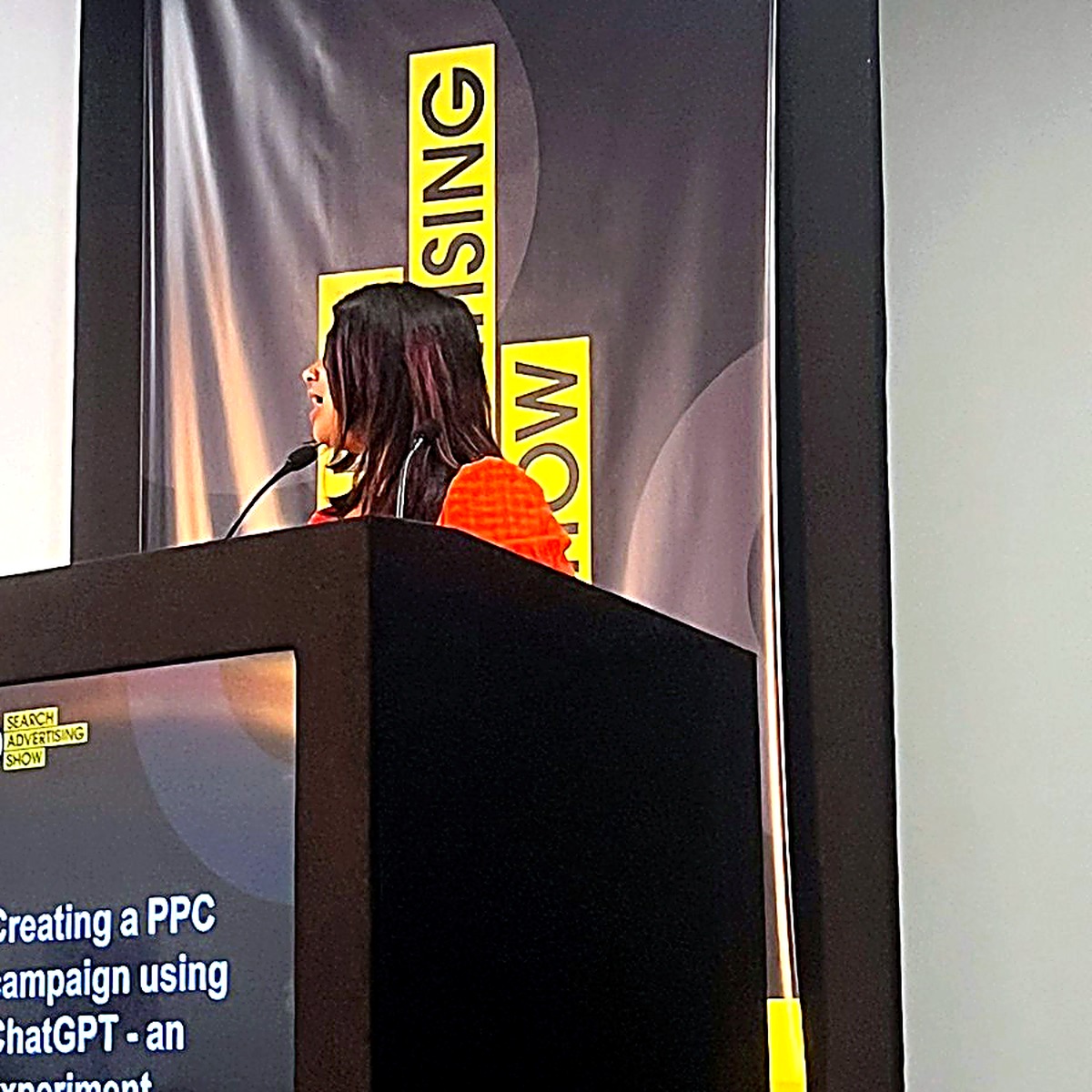 Farah speaking on stage (photo 2)